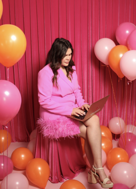 Taley, the realtor mom, is setting up automations on her laptop to save time, surrounded by pink and orange balloons.